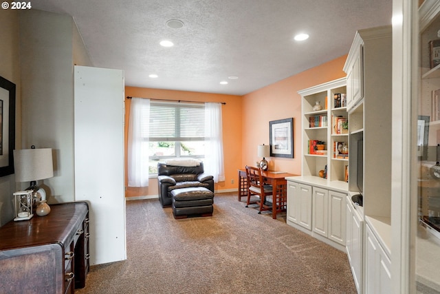 home office featuring carpet floors and a textured ceiling