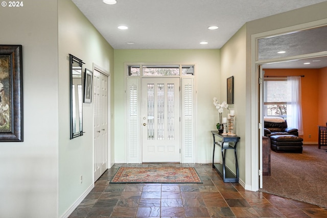 view of carpeted entrance foyer