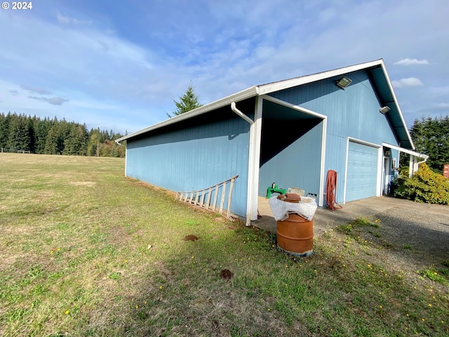 view of outdoor structure with a yard and a garage