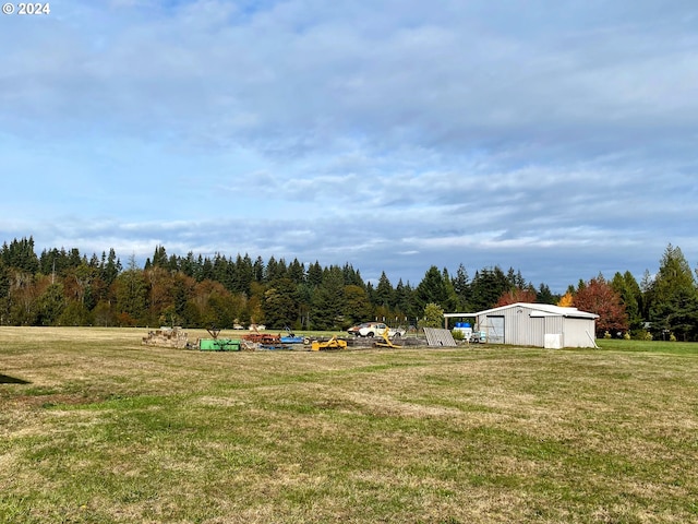 4804 NE 379th St, La Center, WA 98629 - view of green lawn featuring a view of trees, a pole building, and an outdoor structure