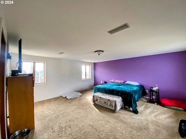 bedroom with multiple windows and carpet floors