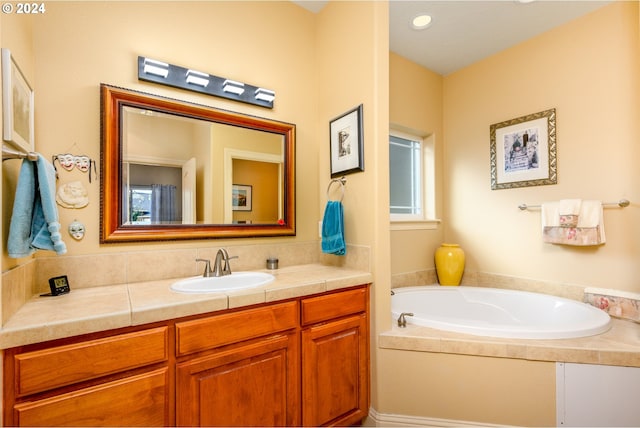 bathroom featuring vanity and a tub