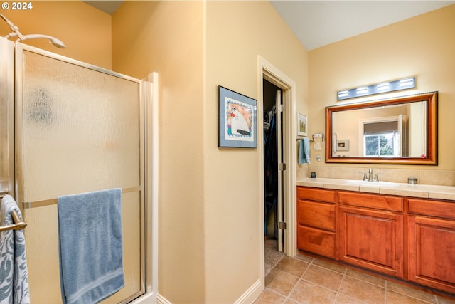 bathroom with vanity, an enclosed shower, and tile patterned floors