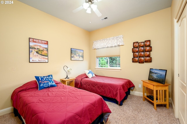 bedroom with a closet, ceiling fan, and carpet flooring