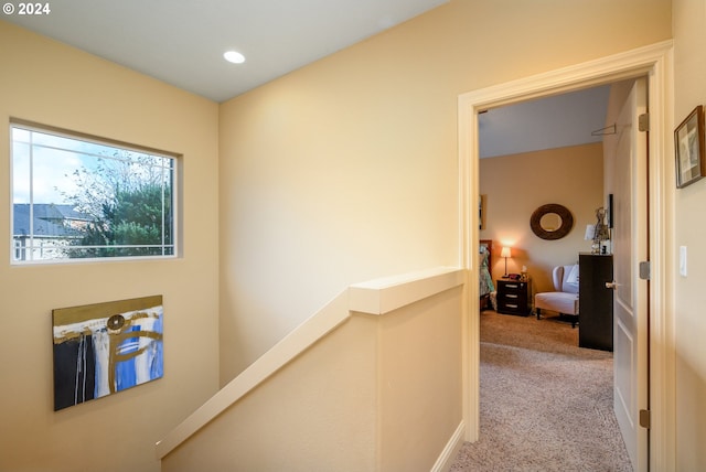 corridor featuring light colored carpet