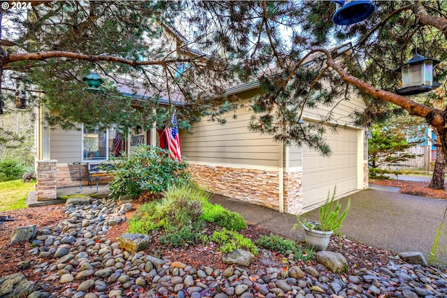 4505 NE Tide Ave, Lincoln City, OR 97367 - view of front of house with stone siding and driveway