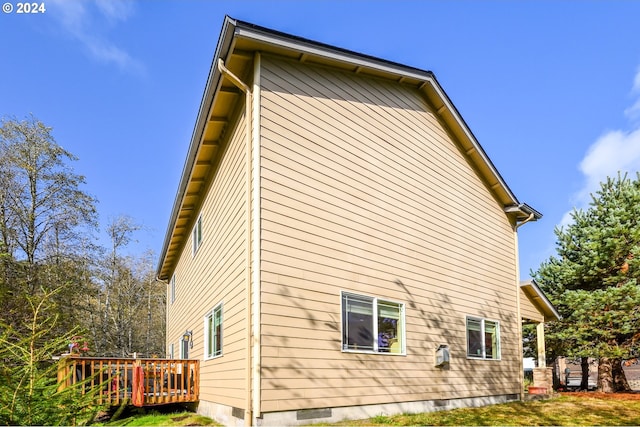 view of side of home with a wooden deck