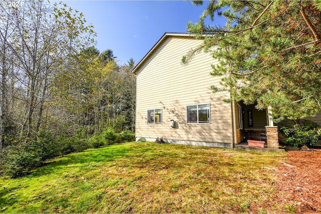 view of home's exterior with a yard