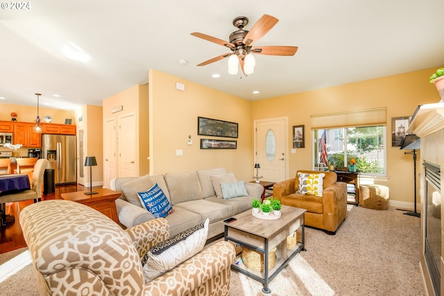 living room featuring light colored carpet and ceiling fan