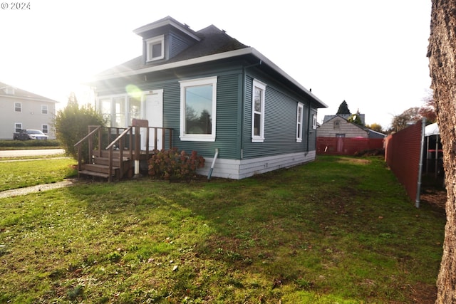 view of property exterior with a yard