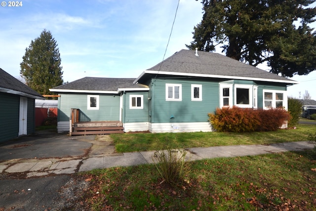 rear view of property with a lawn