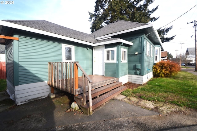 back of house featuring a yard and a deck