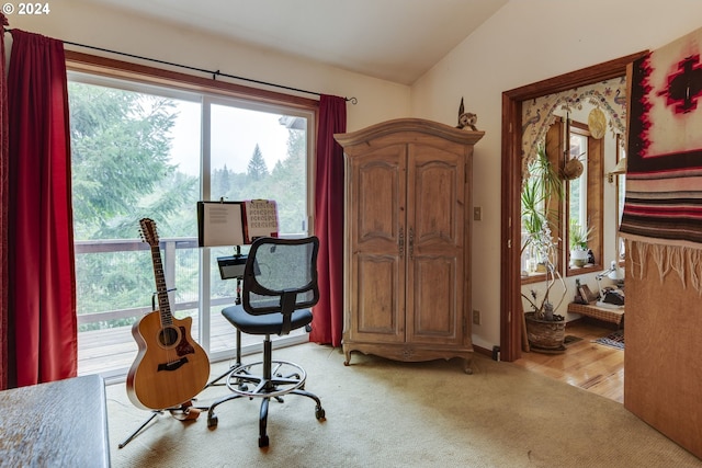 office featuring vaulted ceiling and light hardwood / wood-style flooring