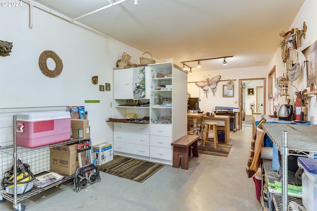 misc room featuring track lighting and concrete flooring