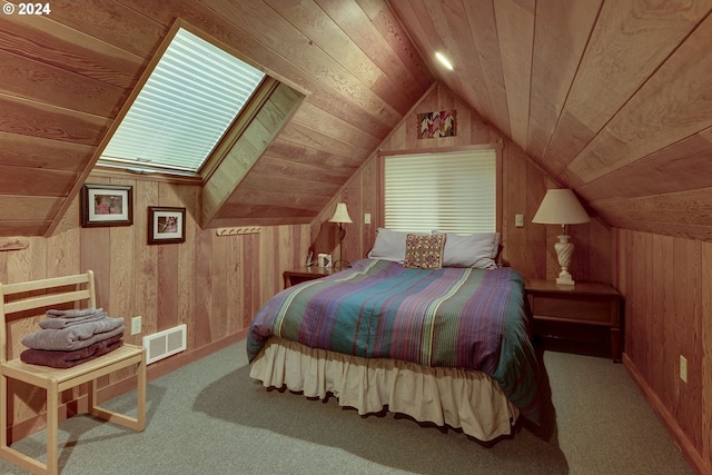 carpeted bedroom with vaulted ceiling with skylight, wood walls, and wooden ceiling