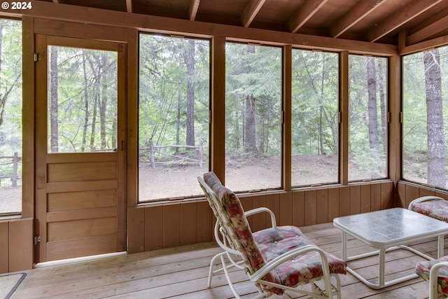 sunroom / solarium featuring beam ceiling