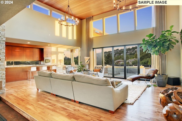 living room with wood ceiling, light hardwood / wood-style flooring, and a wealth of natural light