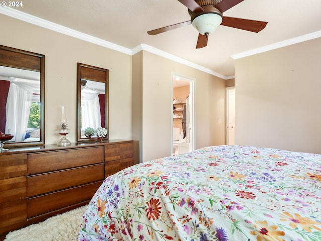 bedroom with crown molding, a ceiling fan, and ensuite bath