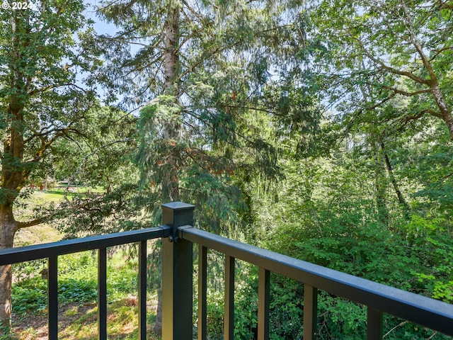 balcony featuring a wooded view