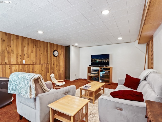 living room featuring wood walls, recessed lighting, and carpet flooring