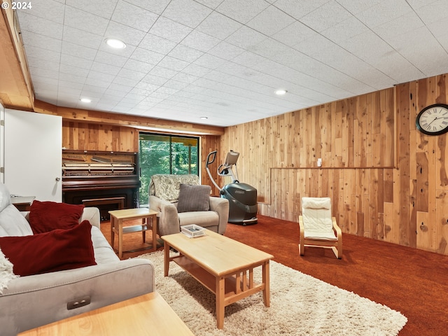 living area featuring wood walls, recessed lighting, and carpet floors