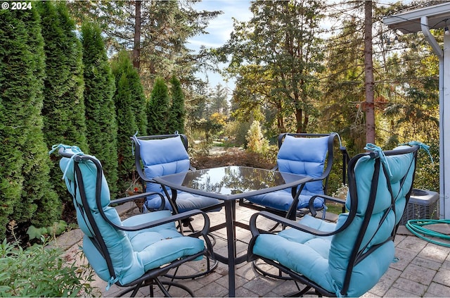 view of patio / terrace with outdoor dining area and central AC