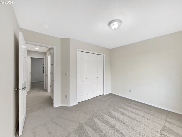 unfurnished bedroom featuring a closet and carpet