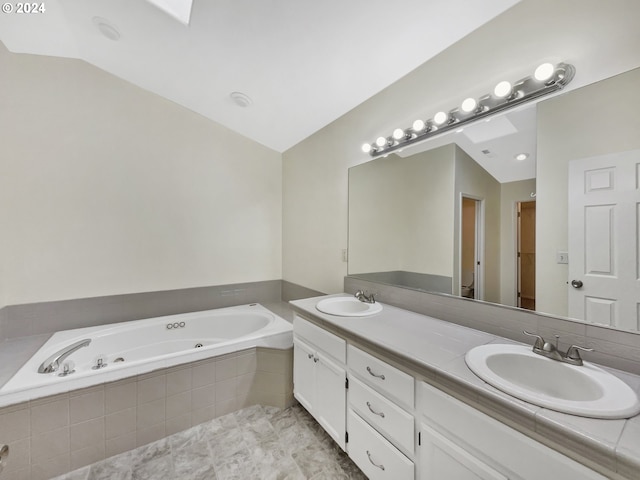 bathroom featuring vanity, lofted ceiling, and tiled bath