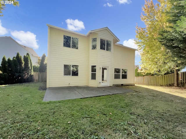 back of house featuring a patio and a lawn