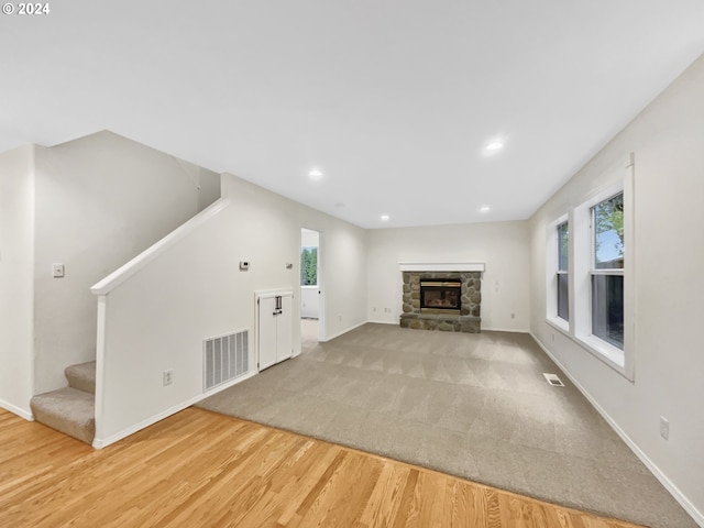 unfurnished living room with a fireplace and wood-type flooring