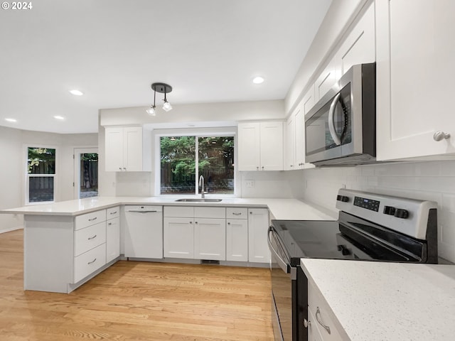 kitchen with sink, light hardwood / wood-style flooring, stainless steel appliances, and white cabinetry