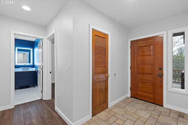 foyer featuring sink and light hardwood / wood-style floors