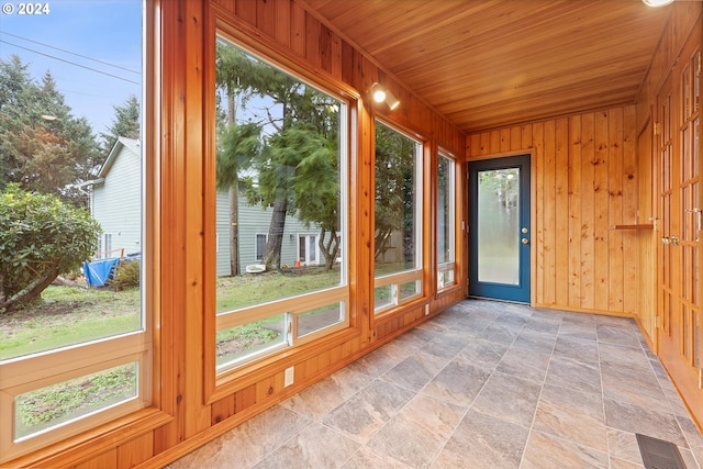 3735 NE Surf Dr, Lincoln City, OR 97367 - unfurnished sunroom with wooden walls, stone finish flooring, and wood ceiling