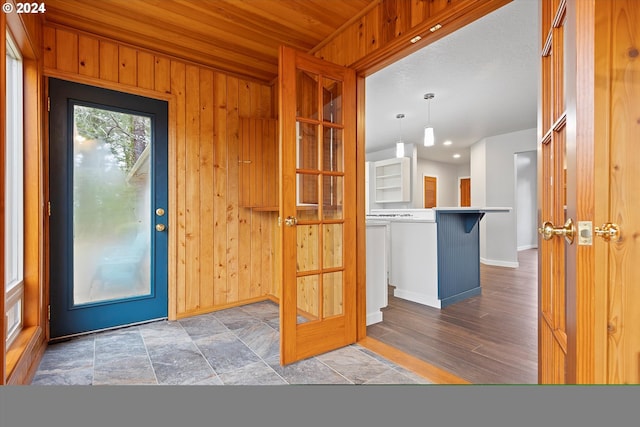 3735 NE Surf Dr, Lincoln City, OR 97367 - foyer entrance with baseboards, wood walls, and wood ceiling