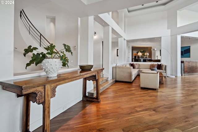 interior space with wood-type flooring and a high ceiling