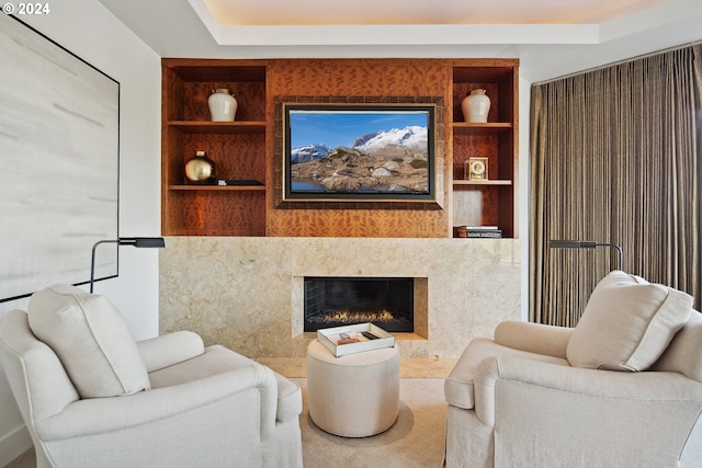 living room with a premium fireplace and built in features