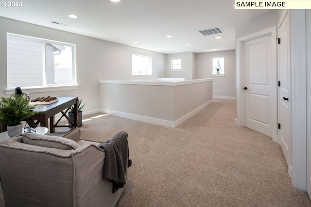 living area with light carpet and a wealth of natural light