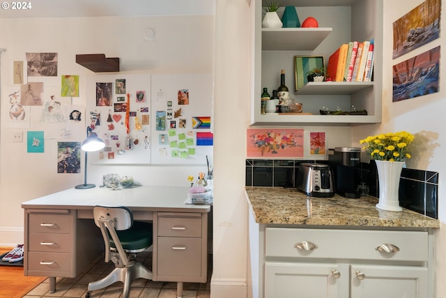 kitchen featuring light stone counters and light hardwood / wood-style flooring