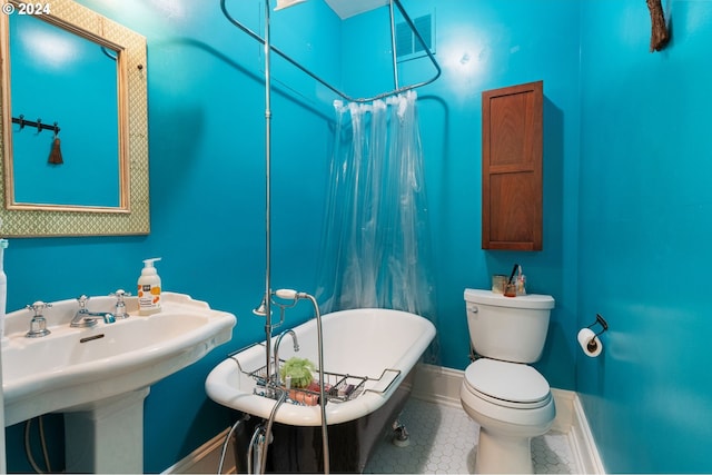 bathroom featuring a bathing tub, tile patterned flooring, and toilet