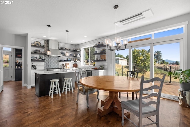 dining room with dark wood-type flooring, recessed lighting, visible vents, and a notable chandelier