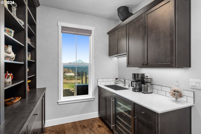 201 Sterling Blvd, White Salmon, WA 98672 - kitchen with beverage cooler, a sink, baseboards, dark brown cabinets, and dark wood-style flooring