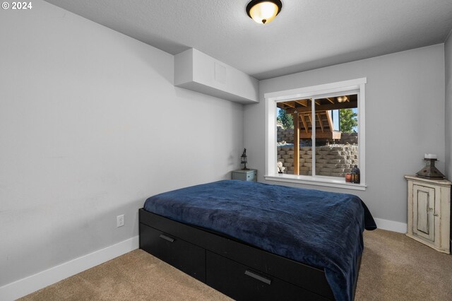 carpeted bedroom featuring a textured ceiling