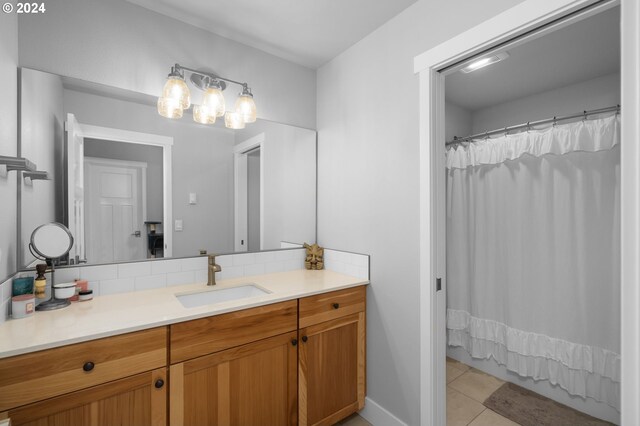 201 Sterling Blvd, White Salmon, WA 98672 - bathroom featuring curtained shower, tile patterned flooring, decorative backsplash, baseboards, and vanity