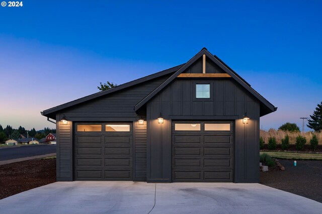 view of garage at dusk