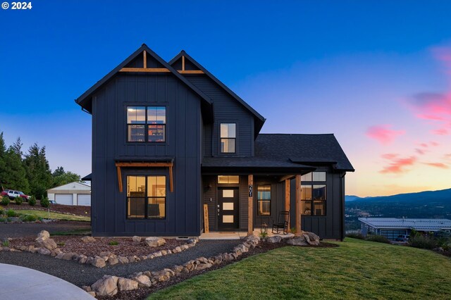 modern farmhouse style home featuring a yard and a garage