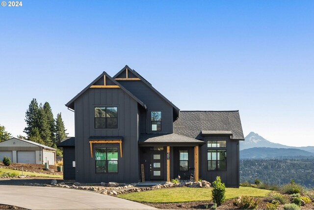 201 Sterling Blvd, White Salmon, WA 98672 - modern inspired farmhouse featuring a front lawn, a mountain view, roof with shingles, board and batten siding, and an outdoor structure