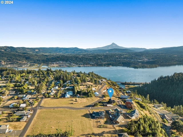 birds eye view of property with a water and mountain view