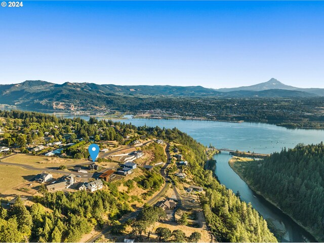 drone / aerial view with a water and mountain view