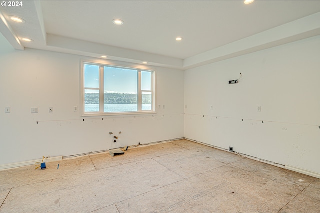 unfurnished room featuring a raised ceiling