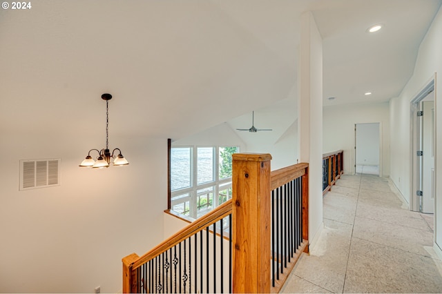 corridor with an inviting chandelier